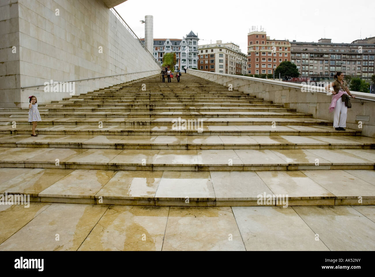 A family descends stairs outside the Guggenheim Museum in Bilbao, Spain. Stock Photo