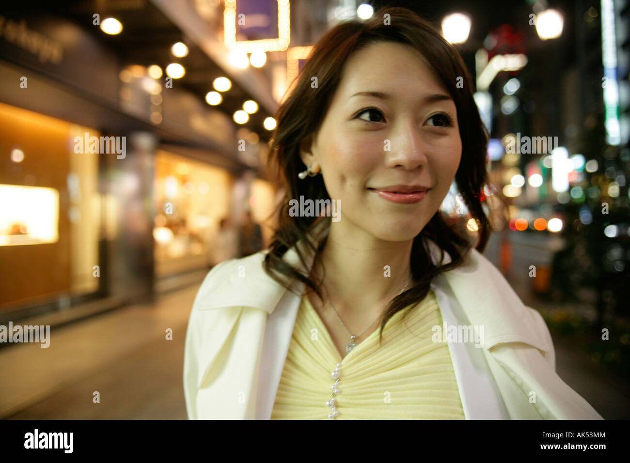 Woman standing on the street at night, close-up Stock Photo - Alamy