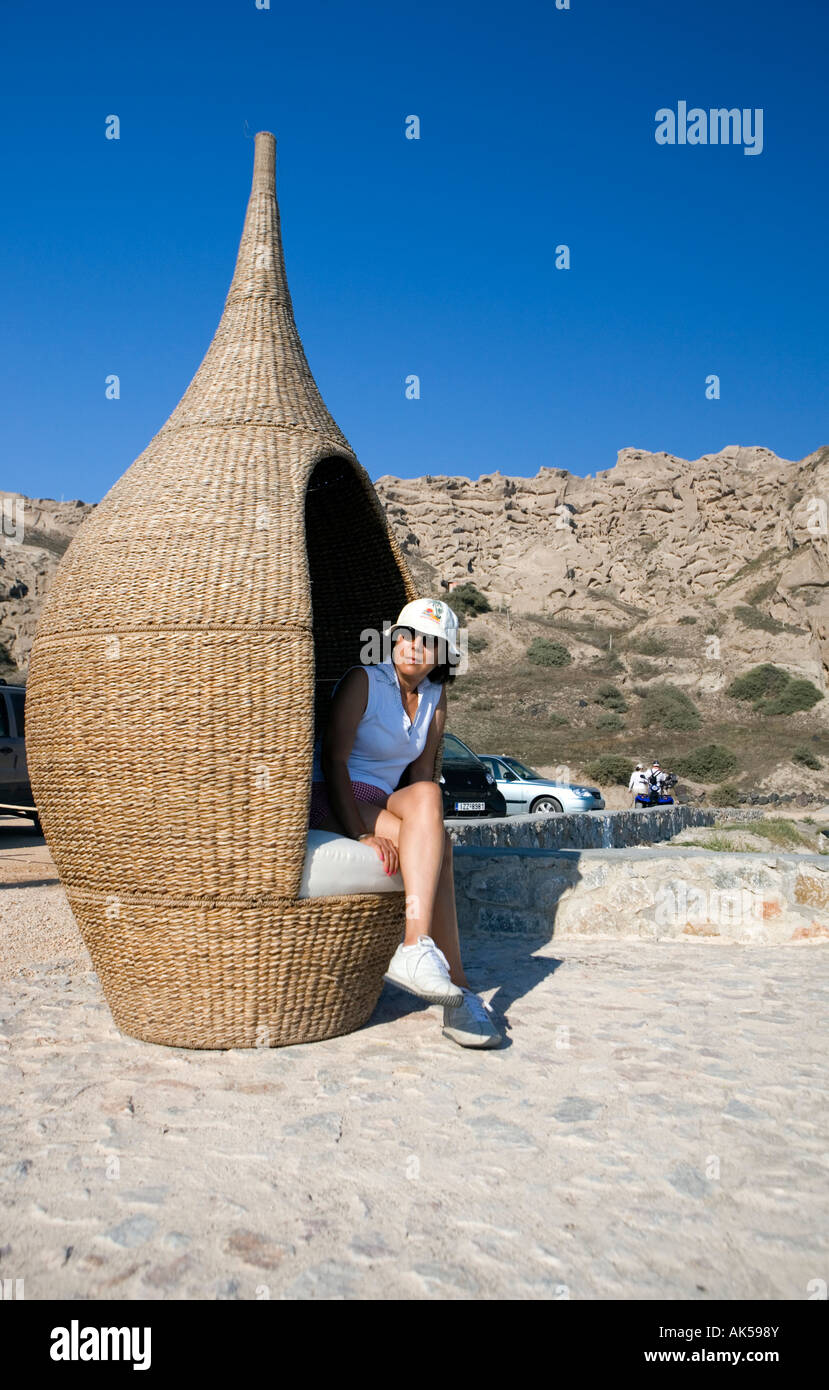 Oriental lady in rattan seat - Santorini, Greece Stock Photo