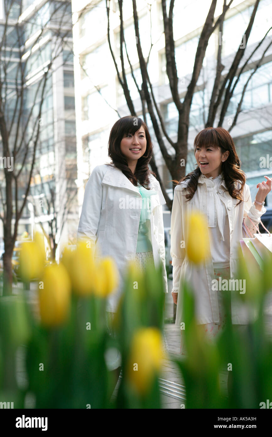 Two women walking on the street Stock Photo - Alamy