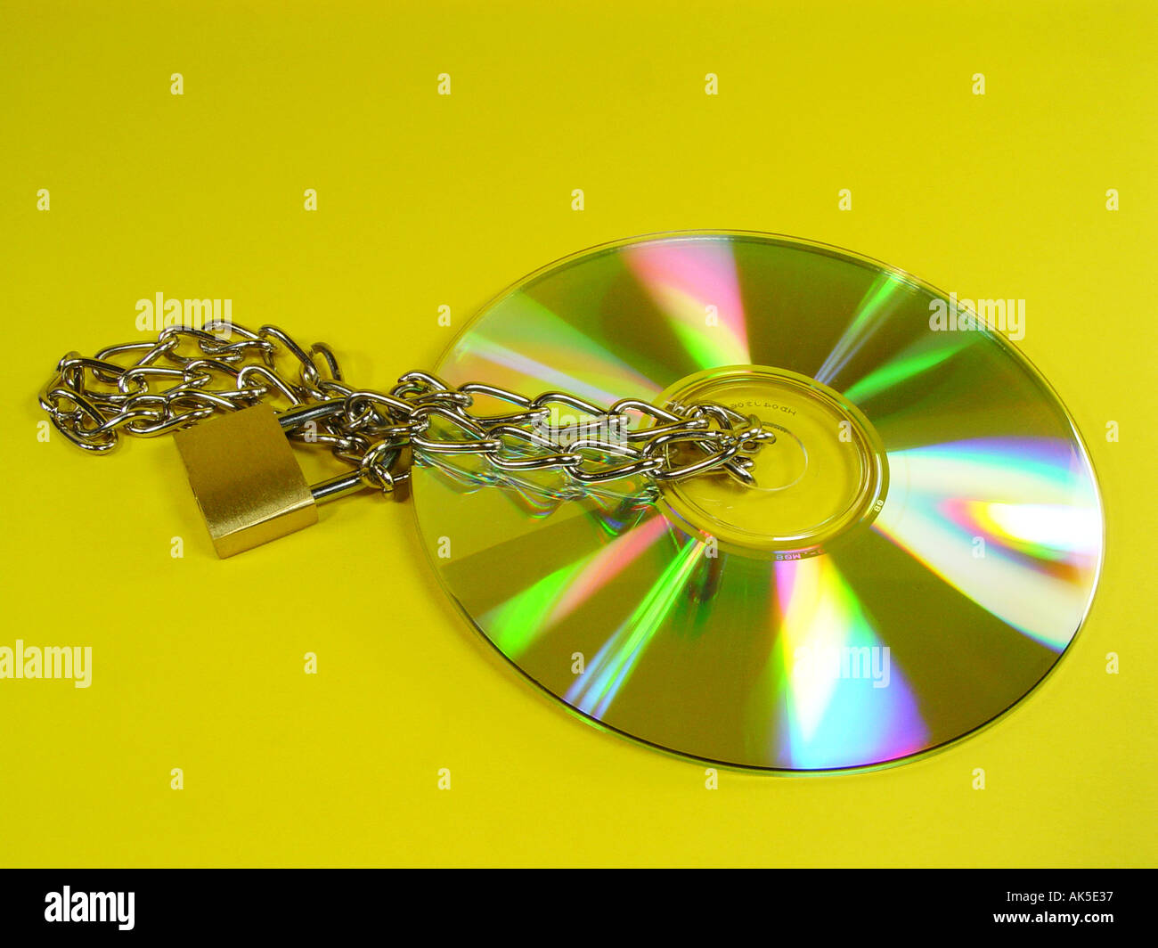 CD Rom with chain and lock as symbol for data security copy protection illegal downloads etc Stock Photo