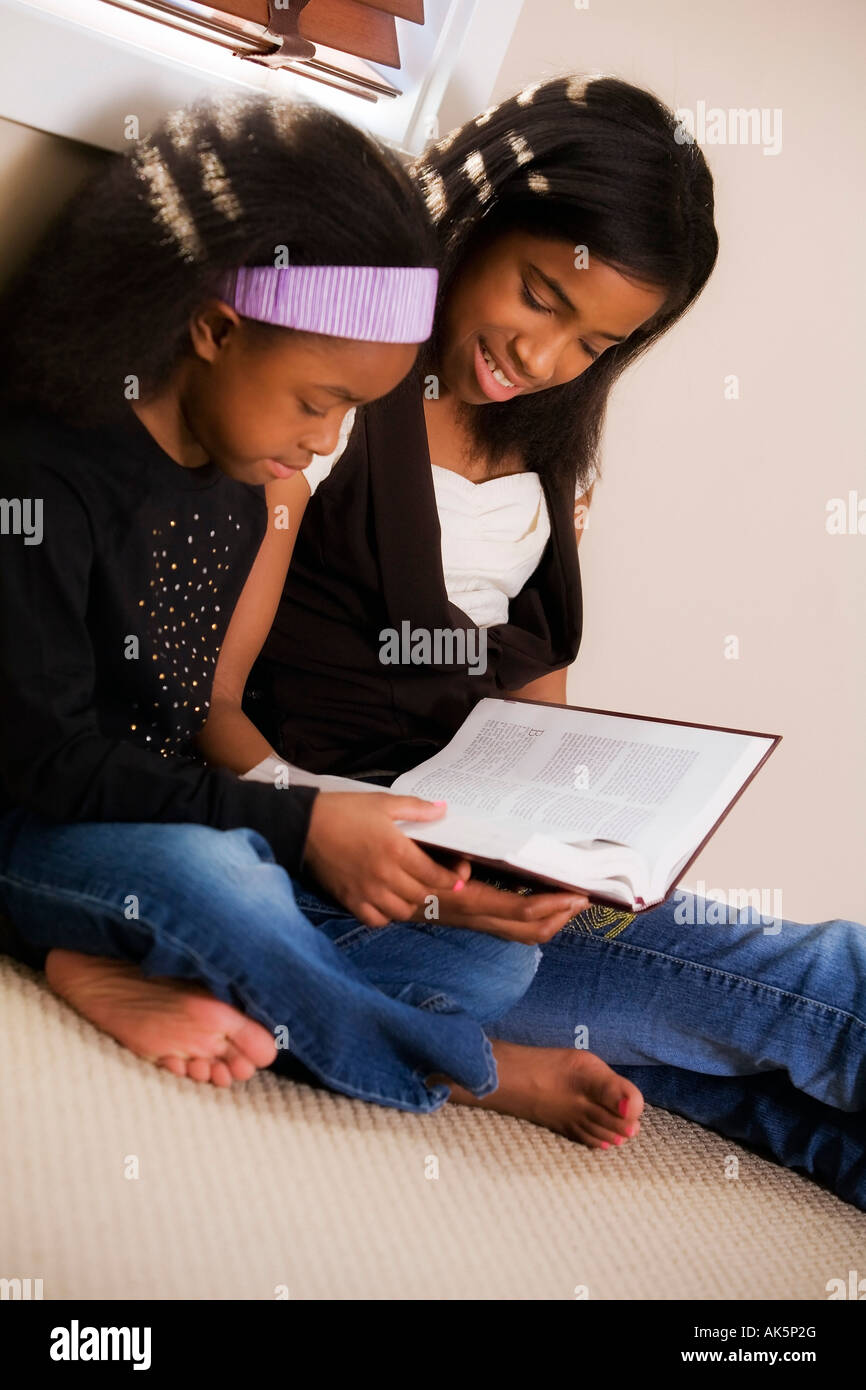 Sisters reading the Bible Stock Photo