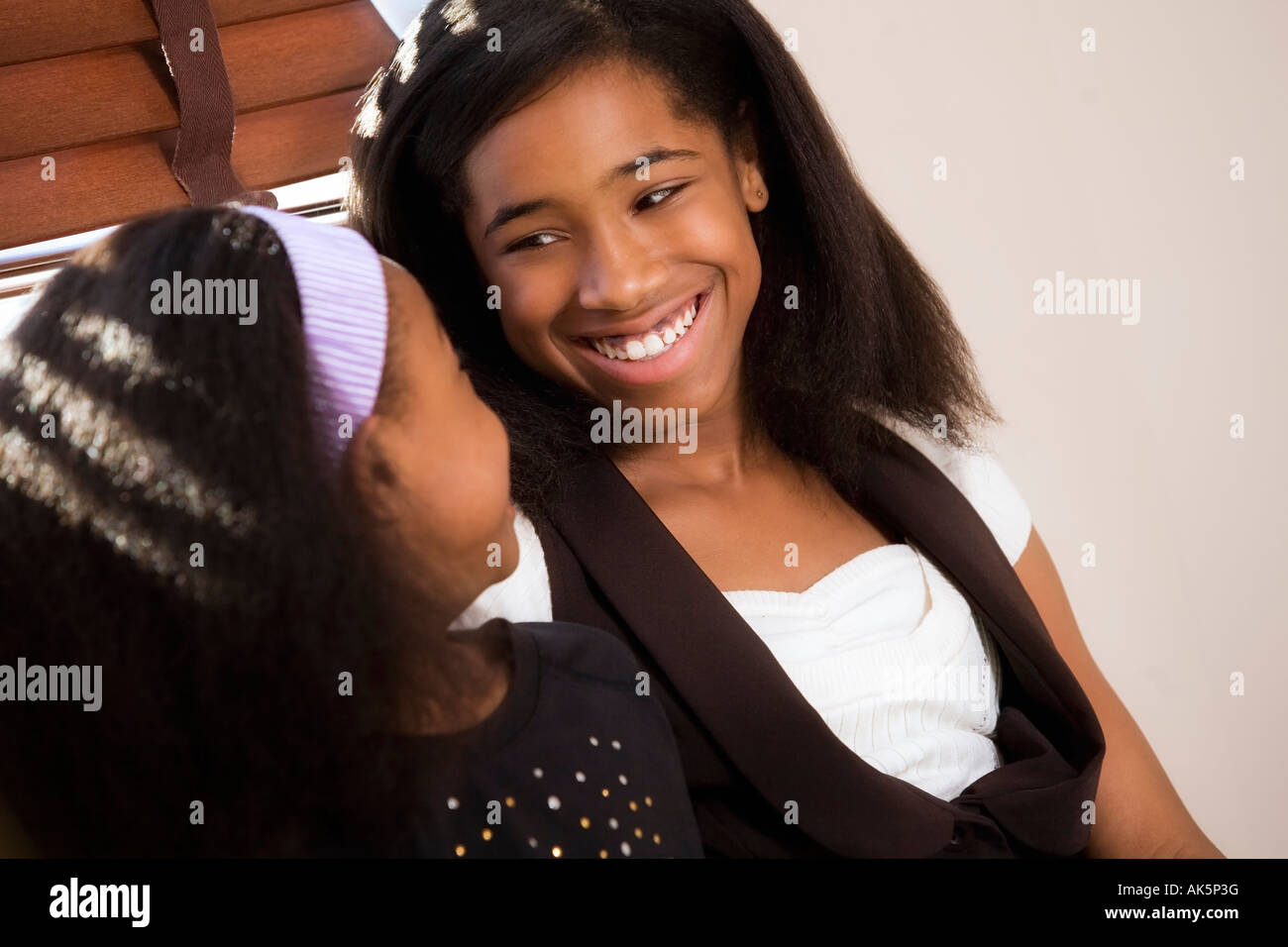 Sisters laughing together Stock Photo