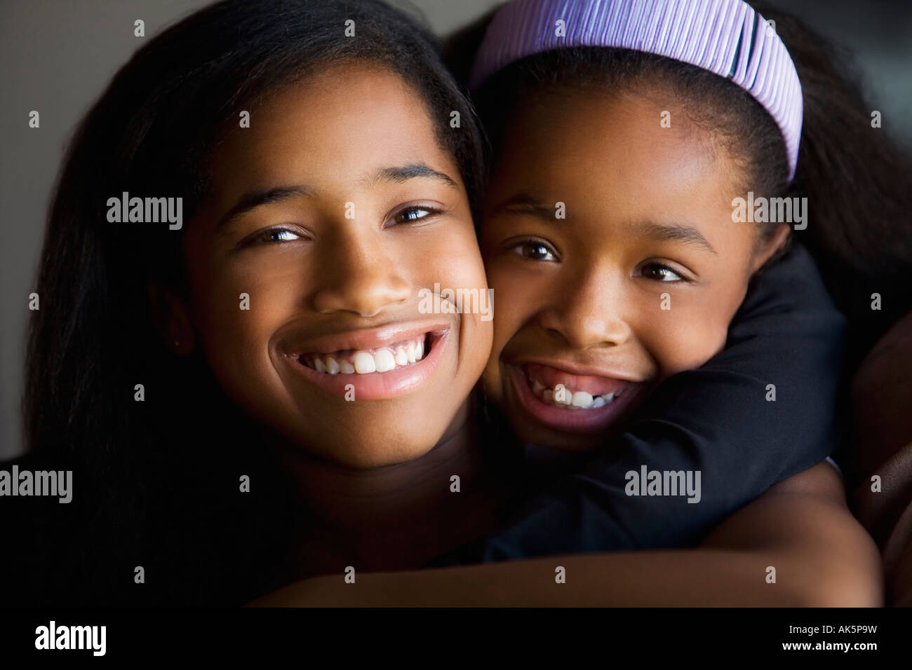 Sisters hugging Stock Photo