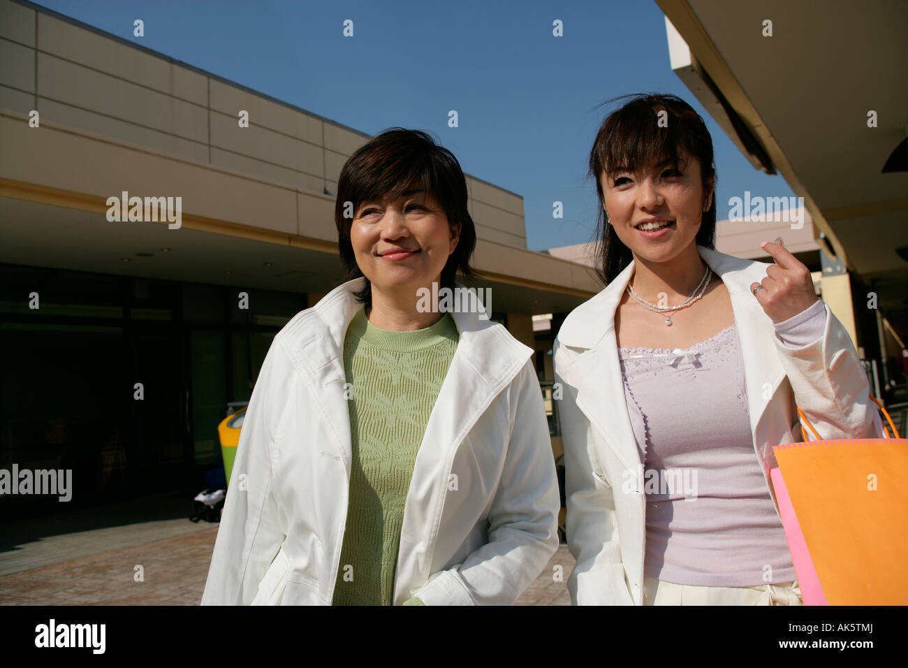 Two women walking on the street Stock Photo - Alamy