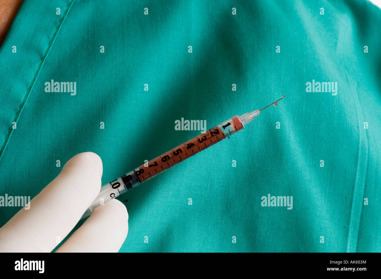 operating surgeon holding a hypodermic needle during surgery Stock