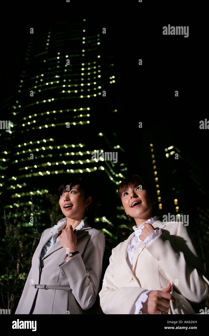Two women walking on the street at night, close-up, low angle Stock ...
