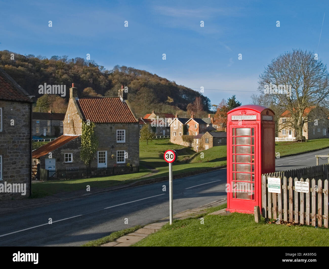 A red public telephone box in the village of Hutton le Hole Rydale North Yorkshire Stock Photo