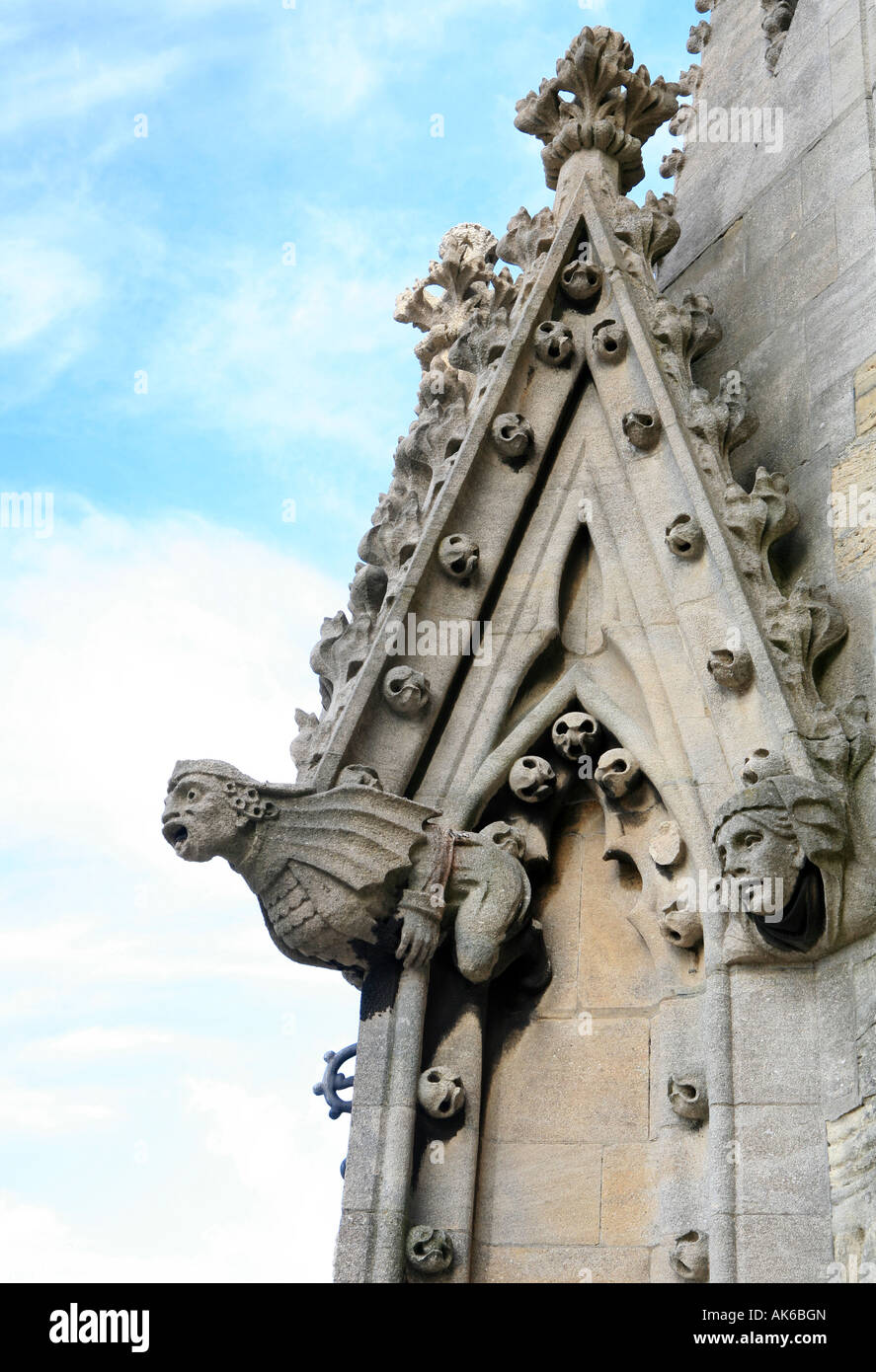 A weathered gargoyle on the spire of a church in Oxford, England Stock Photo