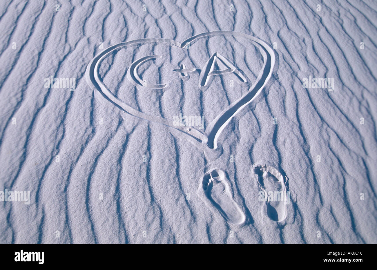 Foot prints and heart with letters in sand structures White Sands national monument New Mexico USA Fussabdruecke und Herz mit Stock Photo