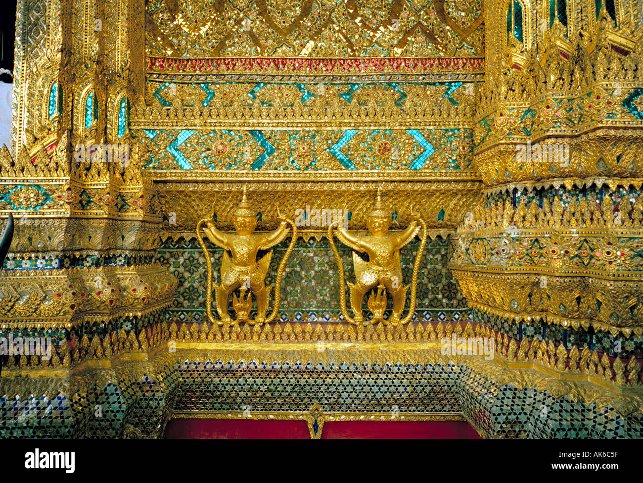 Royal Grand Palace, Bangkok - 112 garudas (mythical man/bird creatures) holding serpents encircle the bot of the Emerald Buddha, Stock Photo