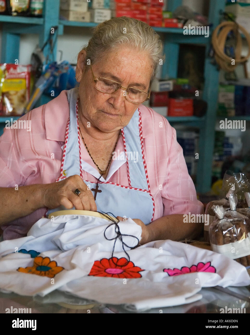 woman doing embroidery in shop Stock Photo Alamy