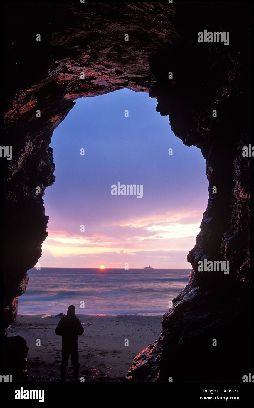 Solitary figure in cave in cliffs at Church Cove the Lizard Cornwall England UK Stock Photo