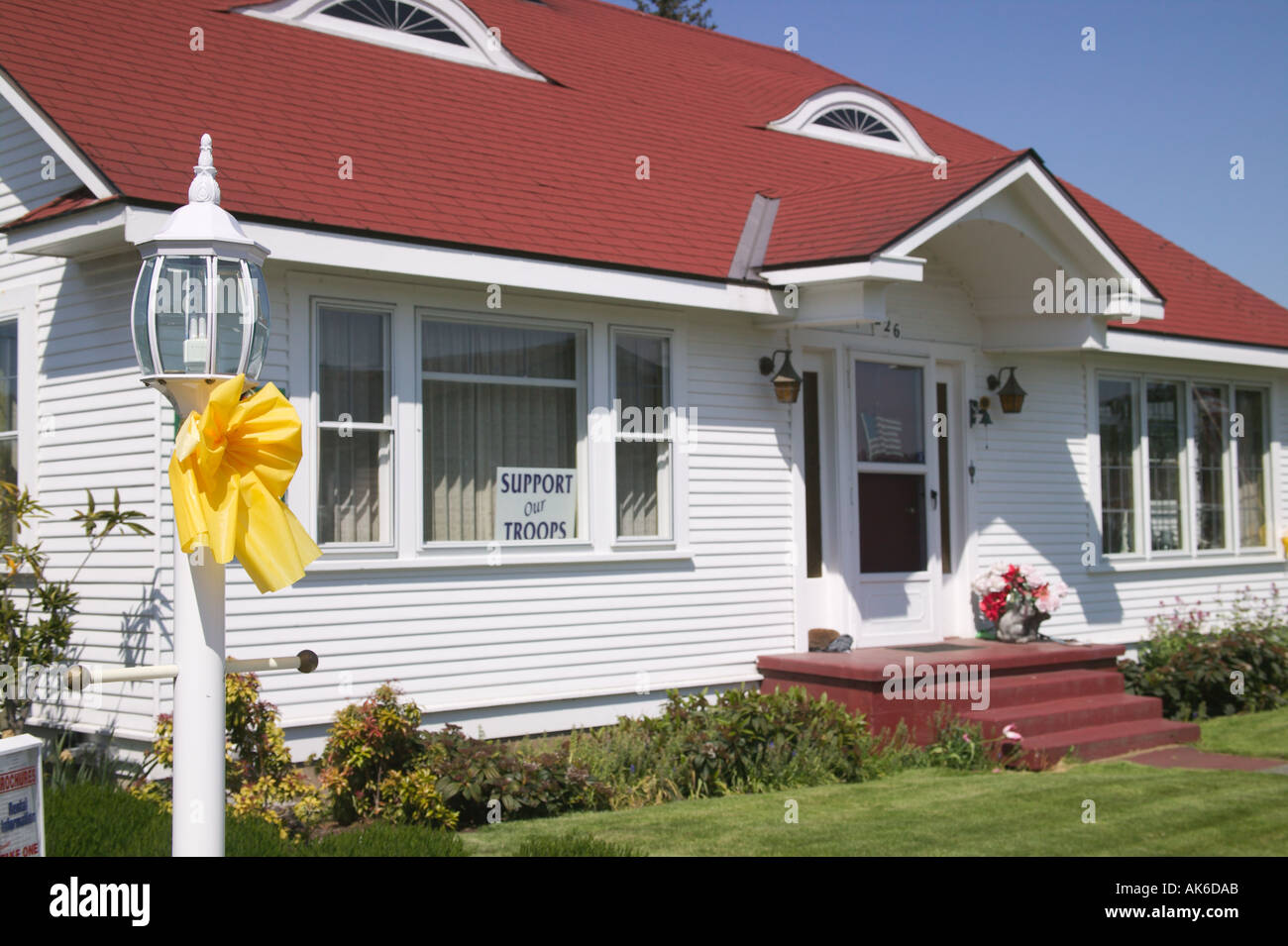 Yellow on Lamp Post White House with Red Roof Behind Sequim Washington Stock - Alamy