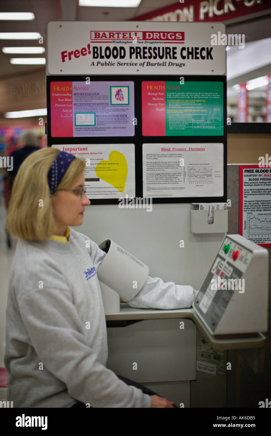 Woman checking blood pressure at drug store Stock Photo