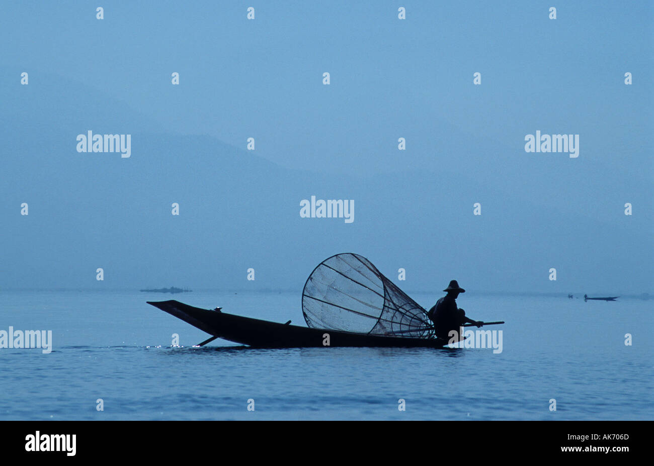 Silhouette of a Fisherman in Rowing Boat on the Inle Lake, Burma Stock Photo