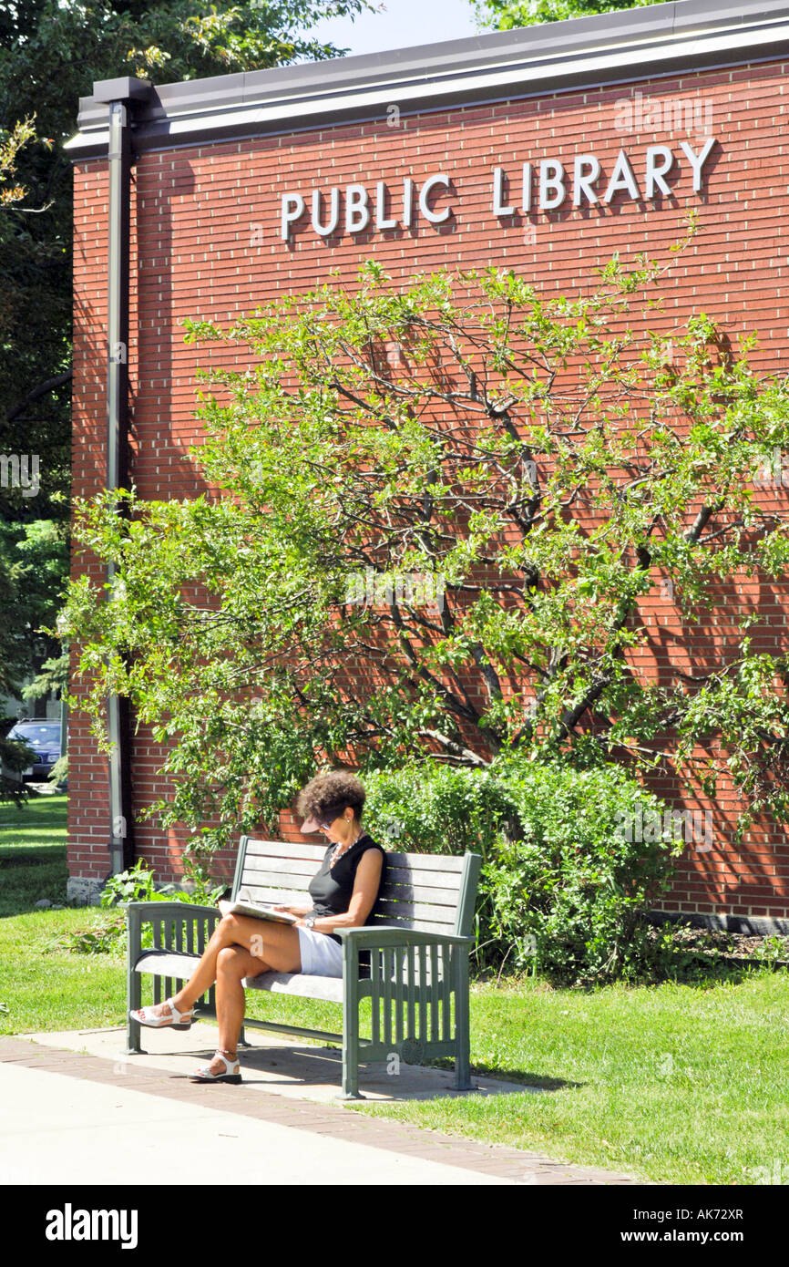 Woman sitting reading her book outside the Public Library in Lake ...