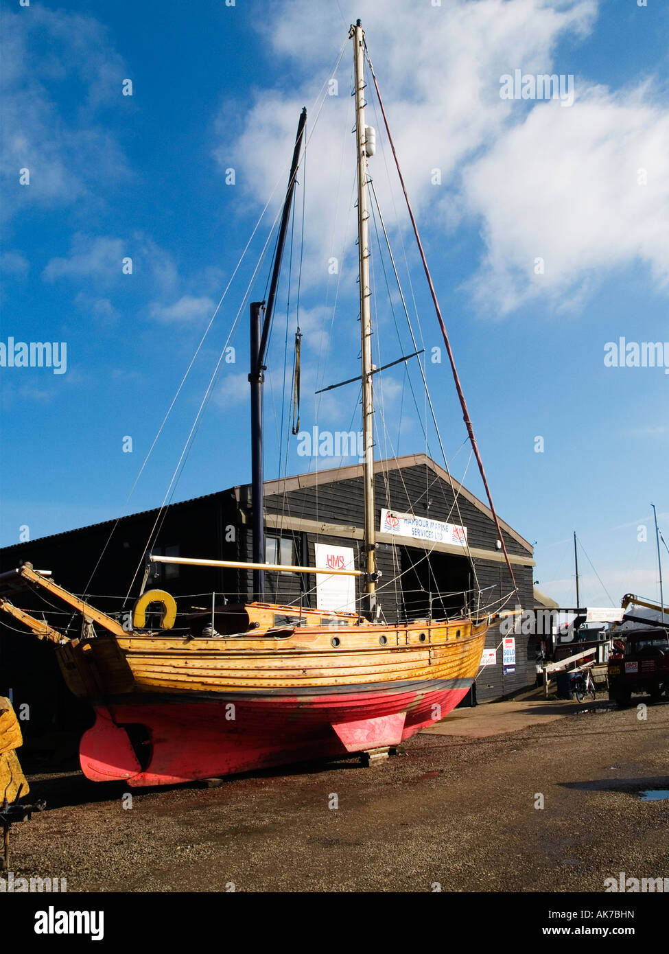 Timber sailing boats being refurbished by traditional boat builders Southwold harbour Suffolk Stock Photo