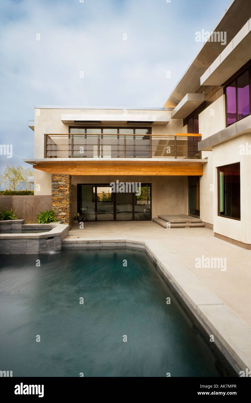 Rear Exterior of Modern Home and Swimming Pool Stock Photo