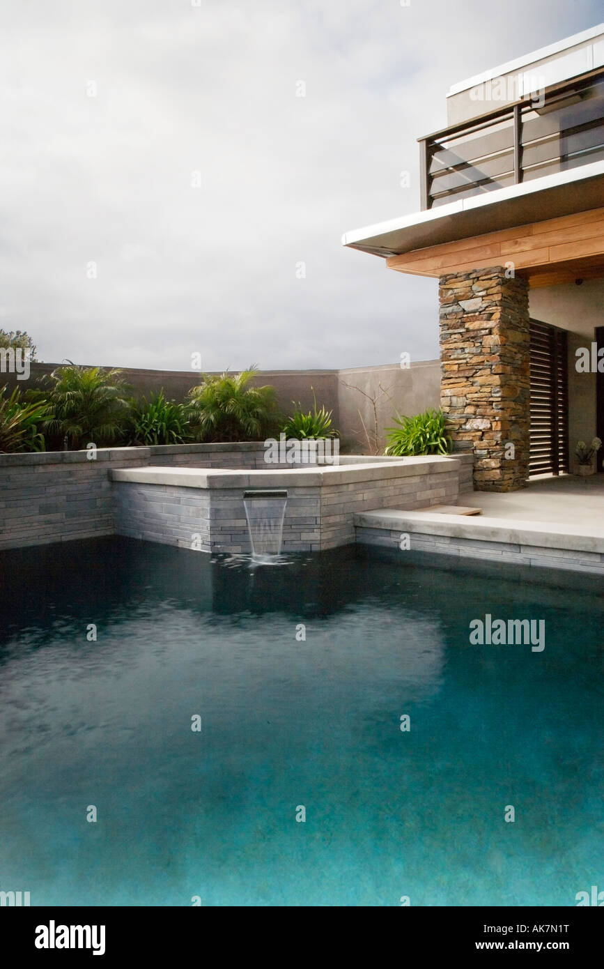 Rear Exterior of Modern Home and Swimming Pool Stock Photo
