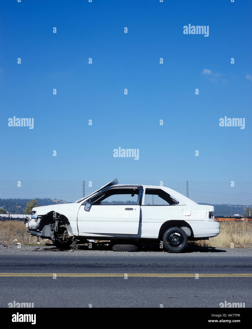Abandoned vehicle by roadside Stock Photo