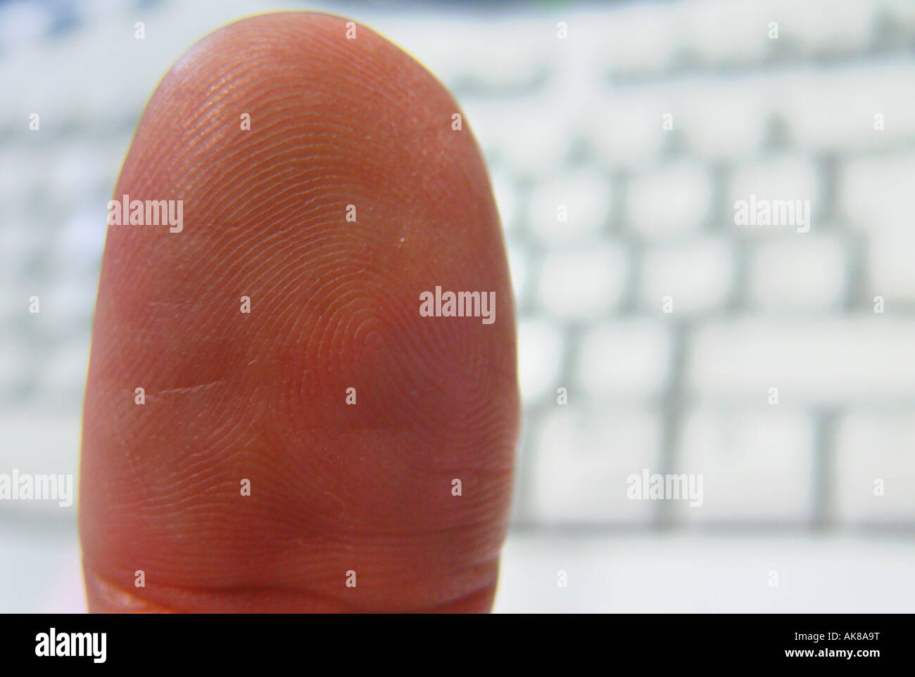 thumb in front of a keypad Stock Photo - Alamy