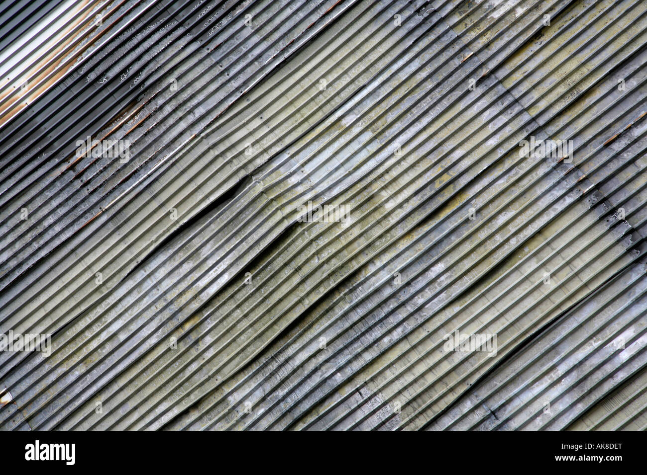 Detail of fire-damaged cladding to disused and burnt-out factory ...