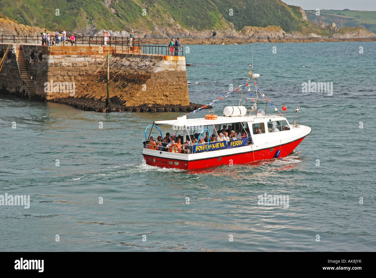 Ferry boat leaving Mevagissey harbour bound for Fowey Stock Photo