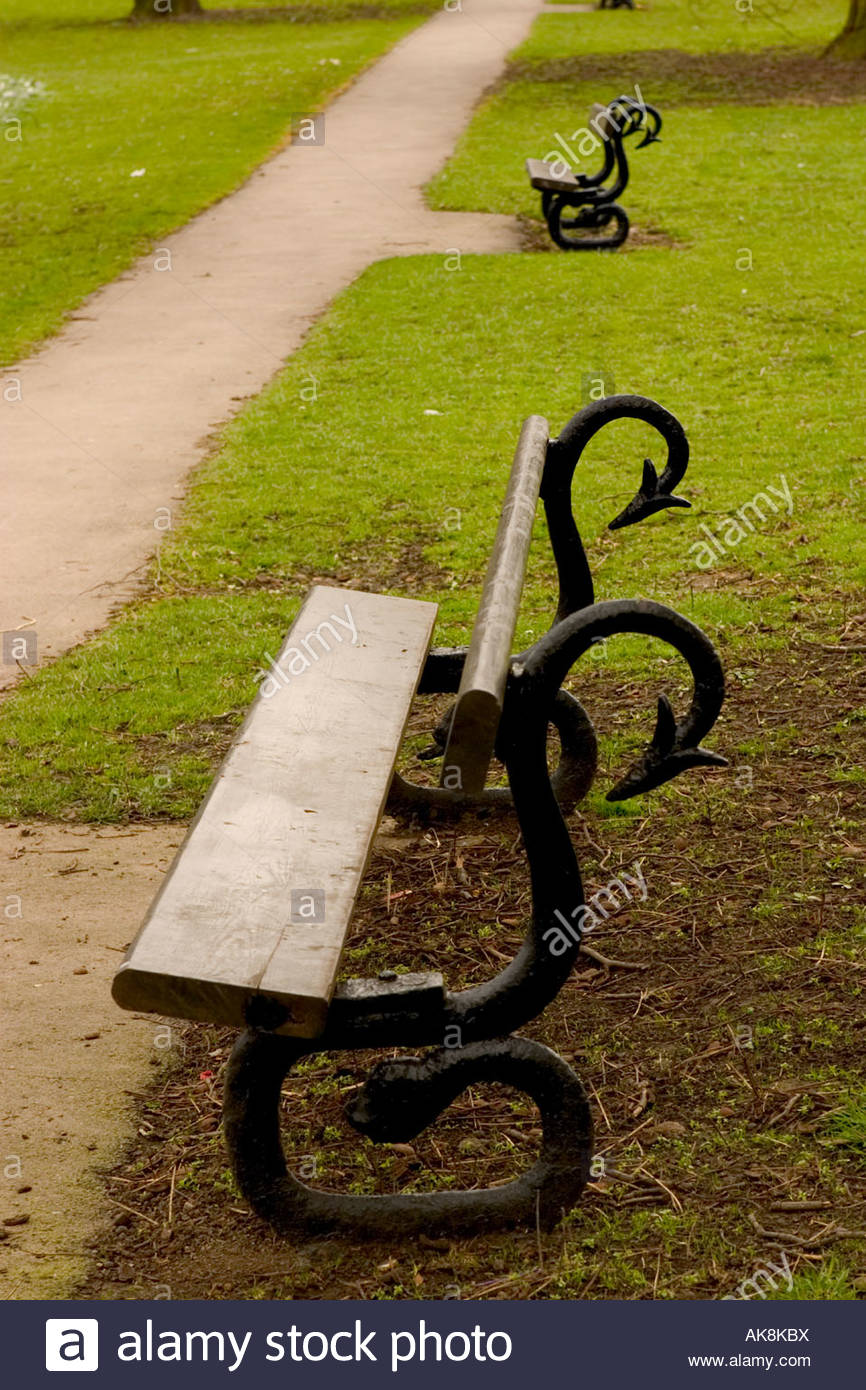 Wooden Park Benches With Snake Like Wrought Iron Frames In