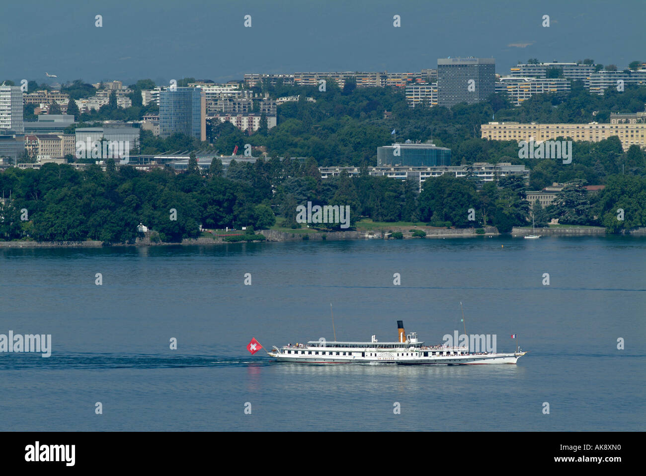 Geneva. Lake Geneva with boat and buildings of internatioal organizations on the other side of the lake. Stock Photo