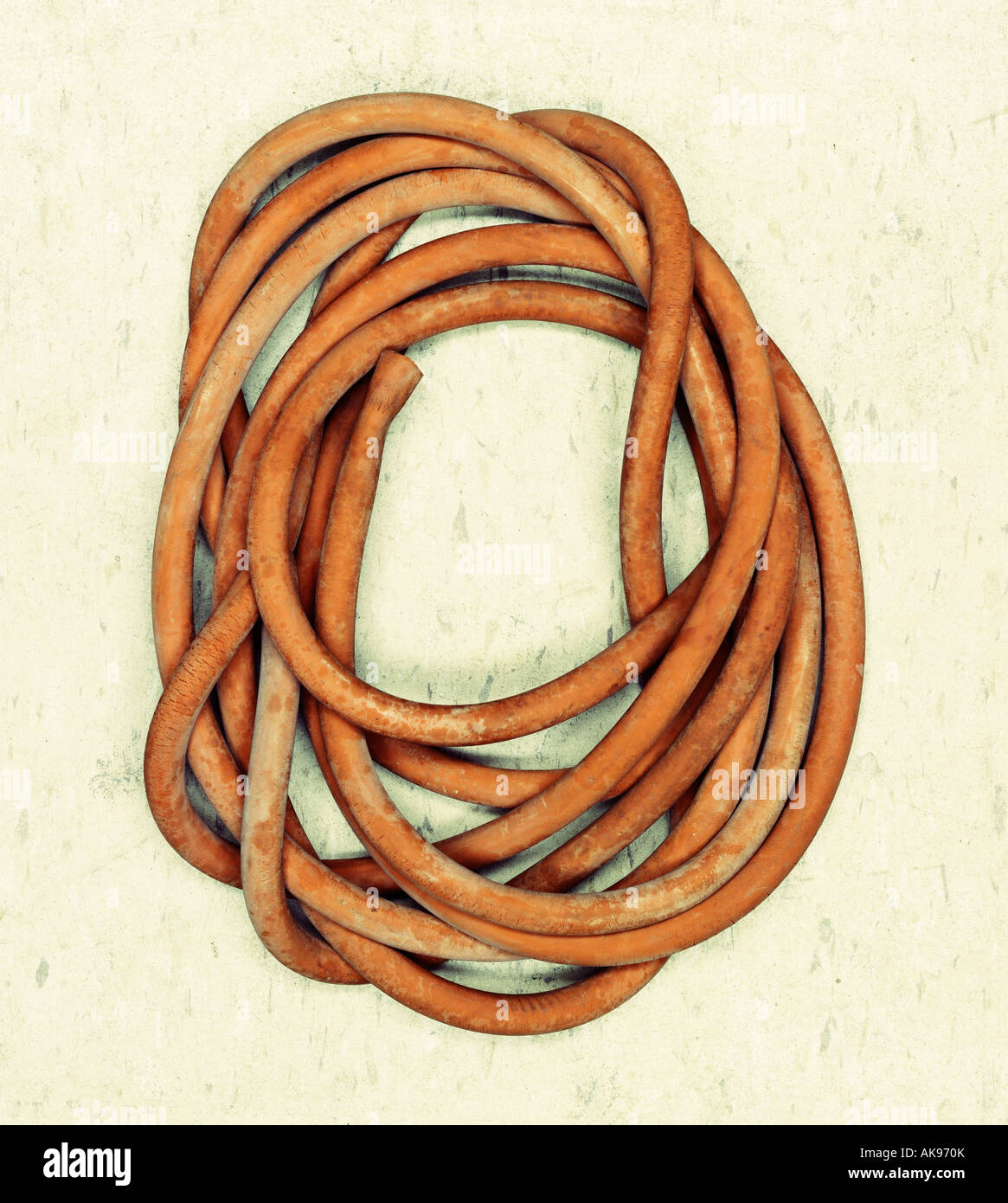 Coil of old rubber tubing Stock Photo