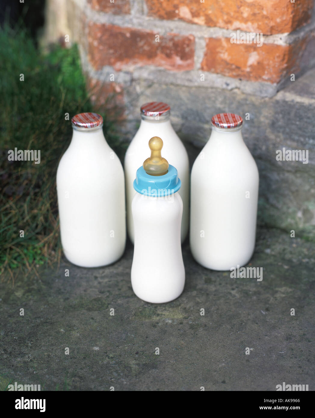 Babys bottle with milk bottles on doorstep Stock Photo