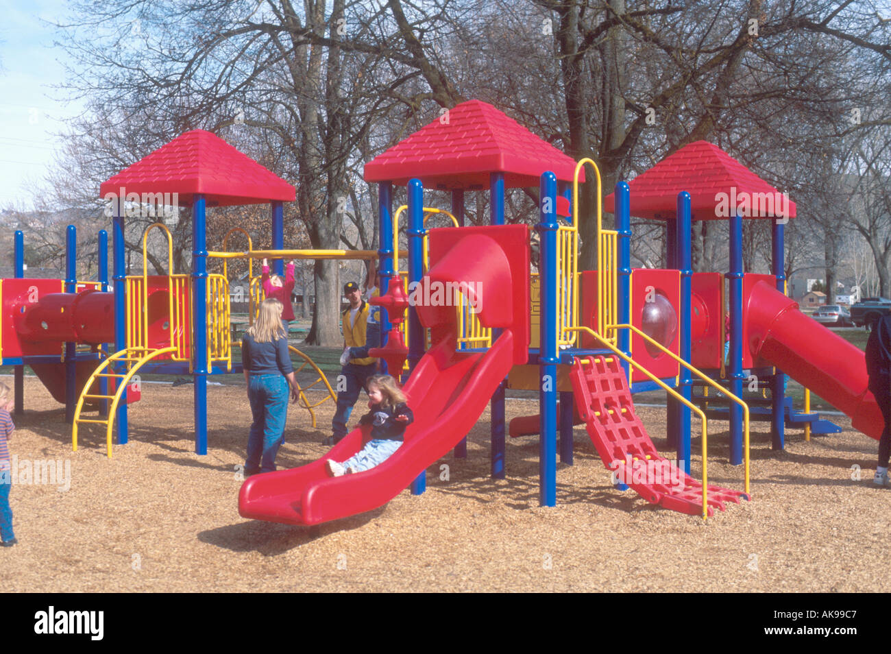 Children playing on plastic playground equipment  Stock Photo