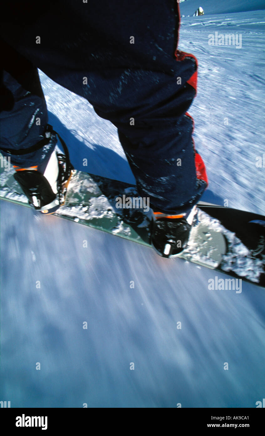Snowboard boots and trousers in action on the slopes Stock Photo