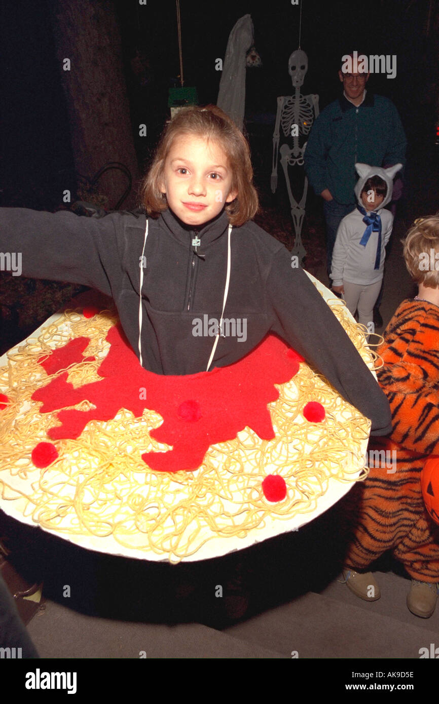 Miss Spaghetti age 10 tasting it up on Halloween night. St Paul Minnesota USA Stock Photo