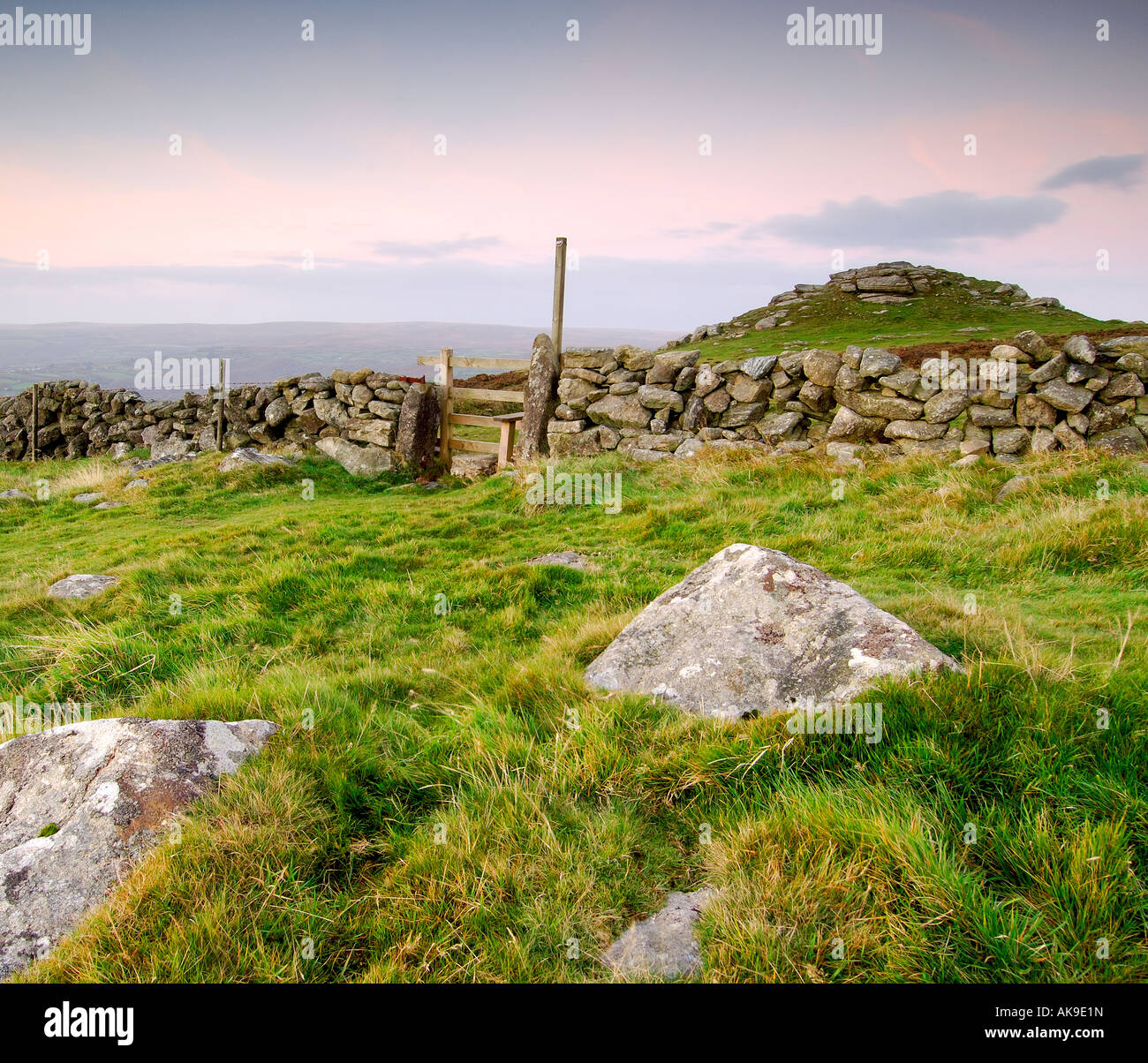 Just before dawn at Buckland Beacon on Dartmoor with a dry stone wall and wooden stile Stock Photo