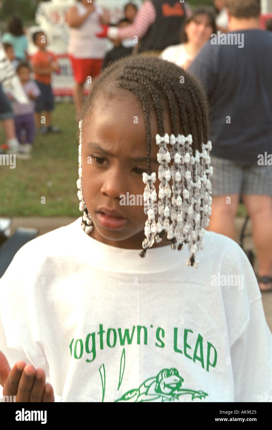 Spectator age 11 waiting for the Frogtown Parade and Festival. St Paul Minnesota USA Stock Photo