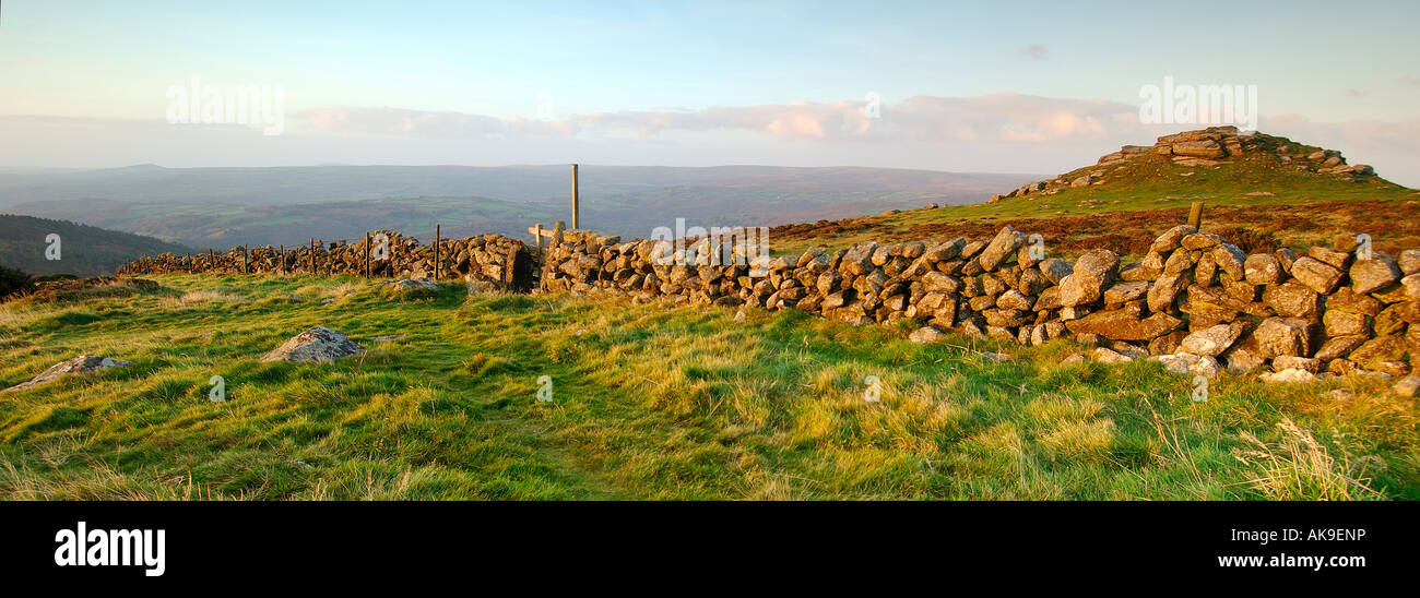 Panoramic format sunrise at Buckland Beacon on Dartmoor with a dry stone wall and wooden stile Stock Photo