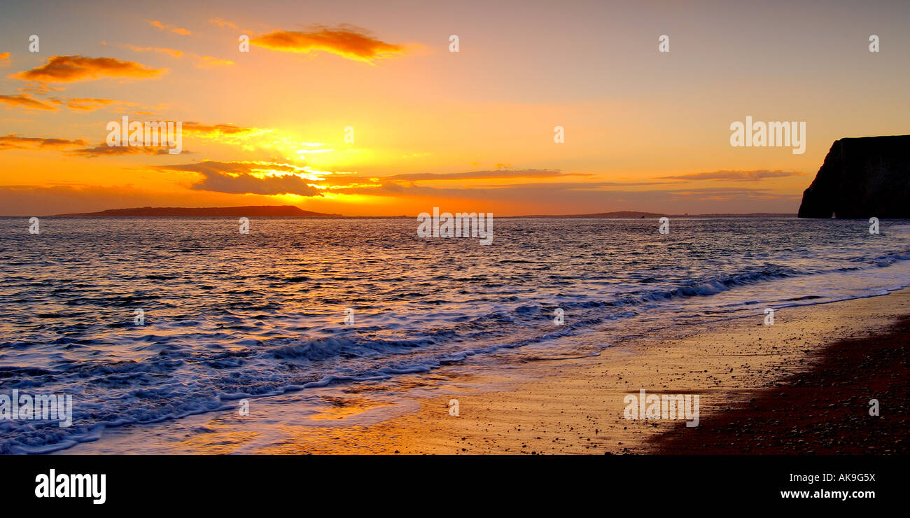 Sunset on the Dorset coast looking West from Swyre head towards Bats Head and Isle of Portland on the horizon Stock Photo