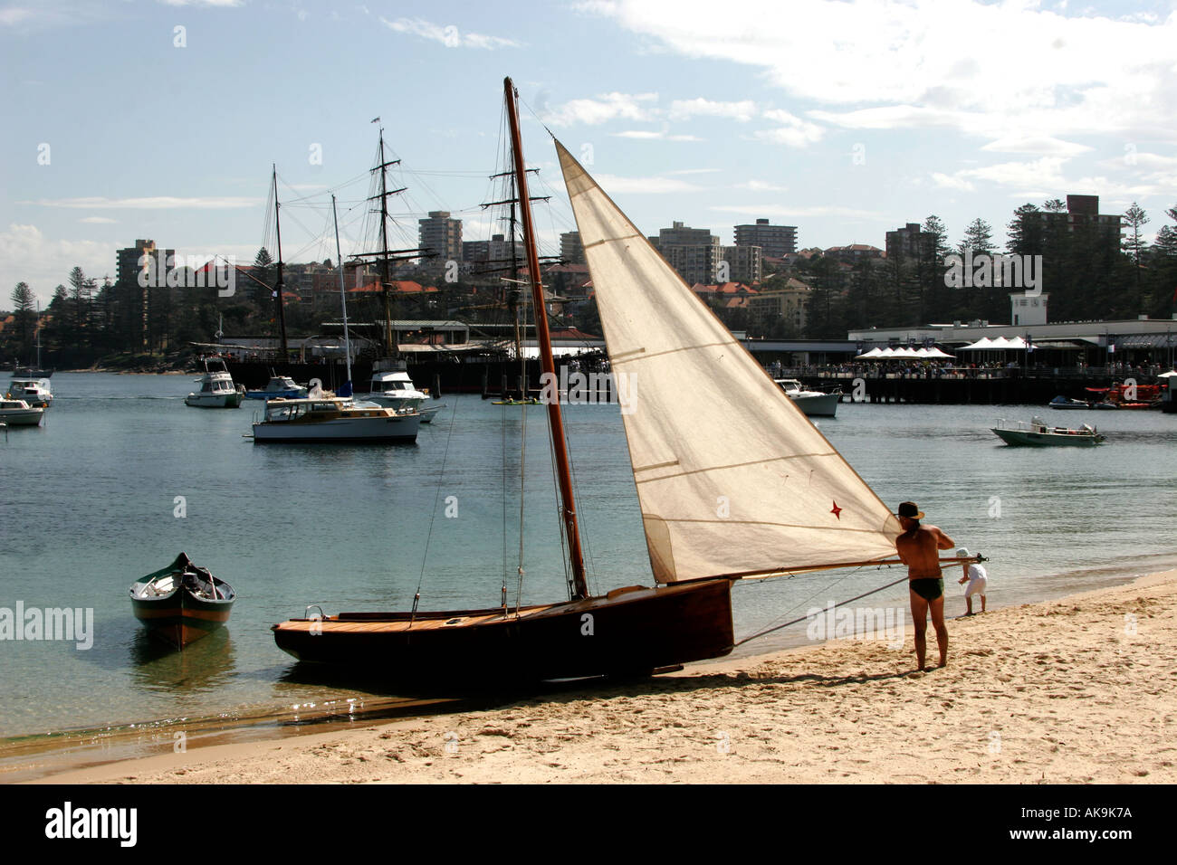 An early 18 footer sailing yacht beached at Manly on Sydney harbour Stock Photo