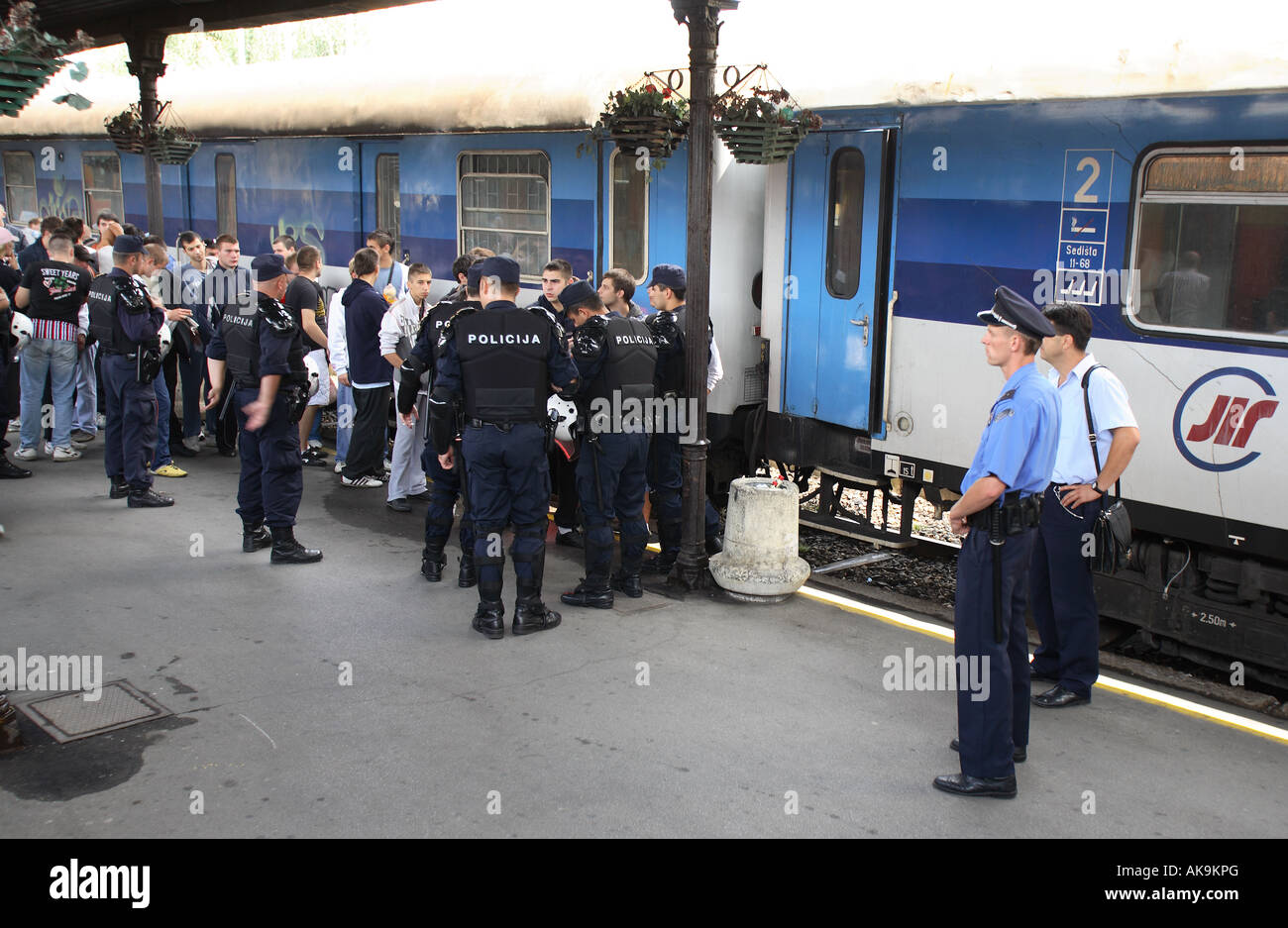 red star belgrade football fans board a train at belgrade station surronded by serbian police Stock Photo