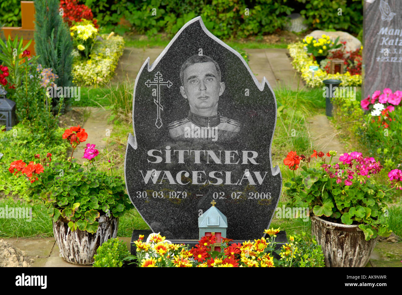 gravestone engraved with image of young man in adidas tracksuit Stock Photo