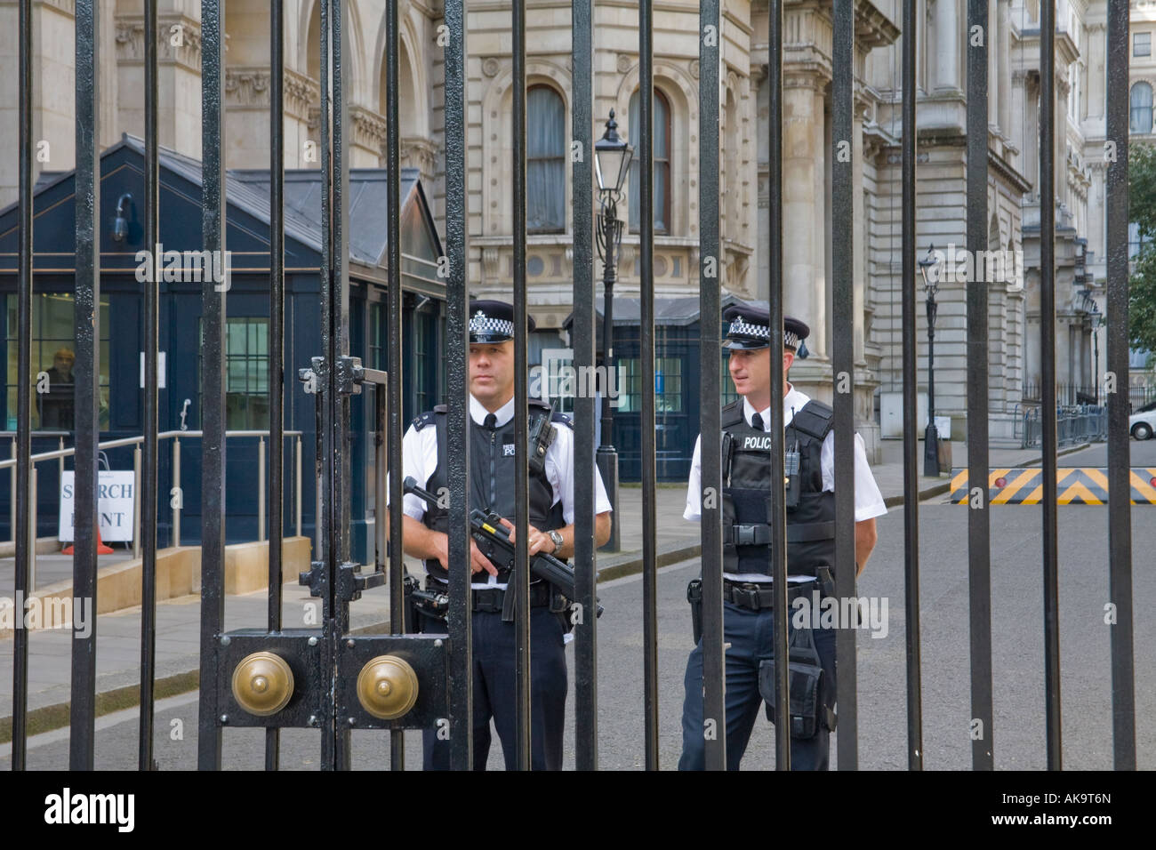 Armed police inside the gates of Downing Street London England Stock Photo