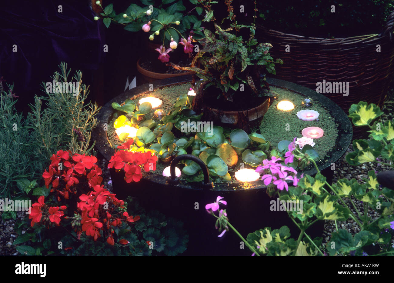 Woodside Rd Chester Garden Lighting Candles in pots floating in water feature Stock Photo