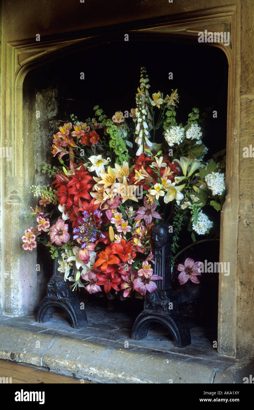 The Malt House Gloucestershire Flower arrangement in Dining Room fire place lilies Stock Photo