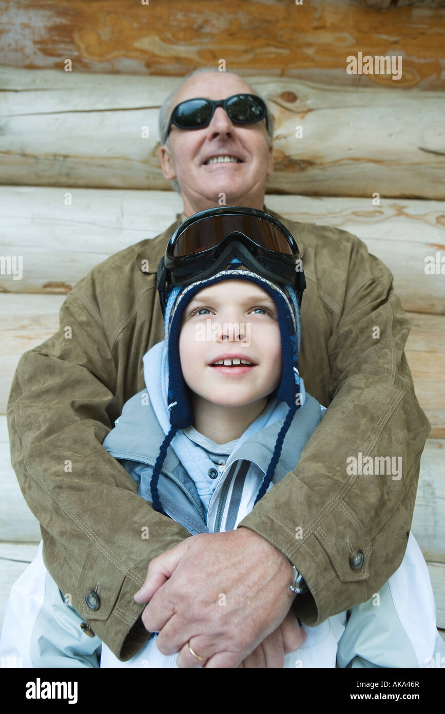 Grandfather embracing grandson, dressed in winter clothing, portrait Stock Photo