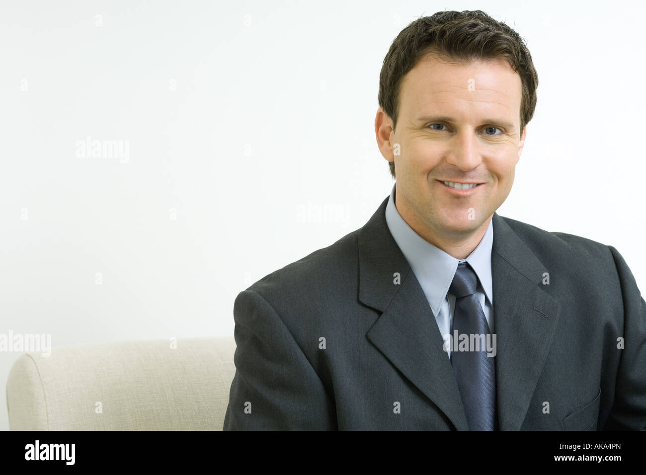 Businessman smiling at camera, portrait Stock Photo - Alamy