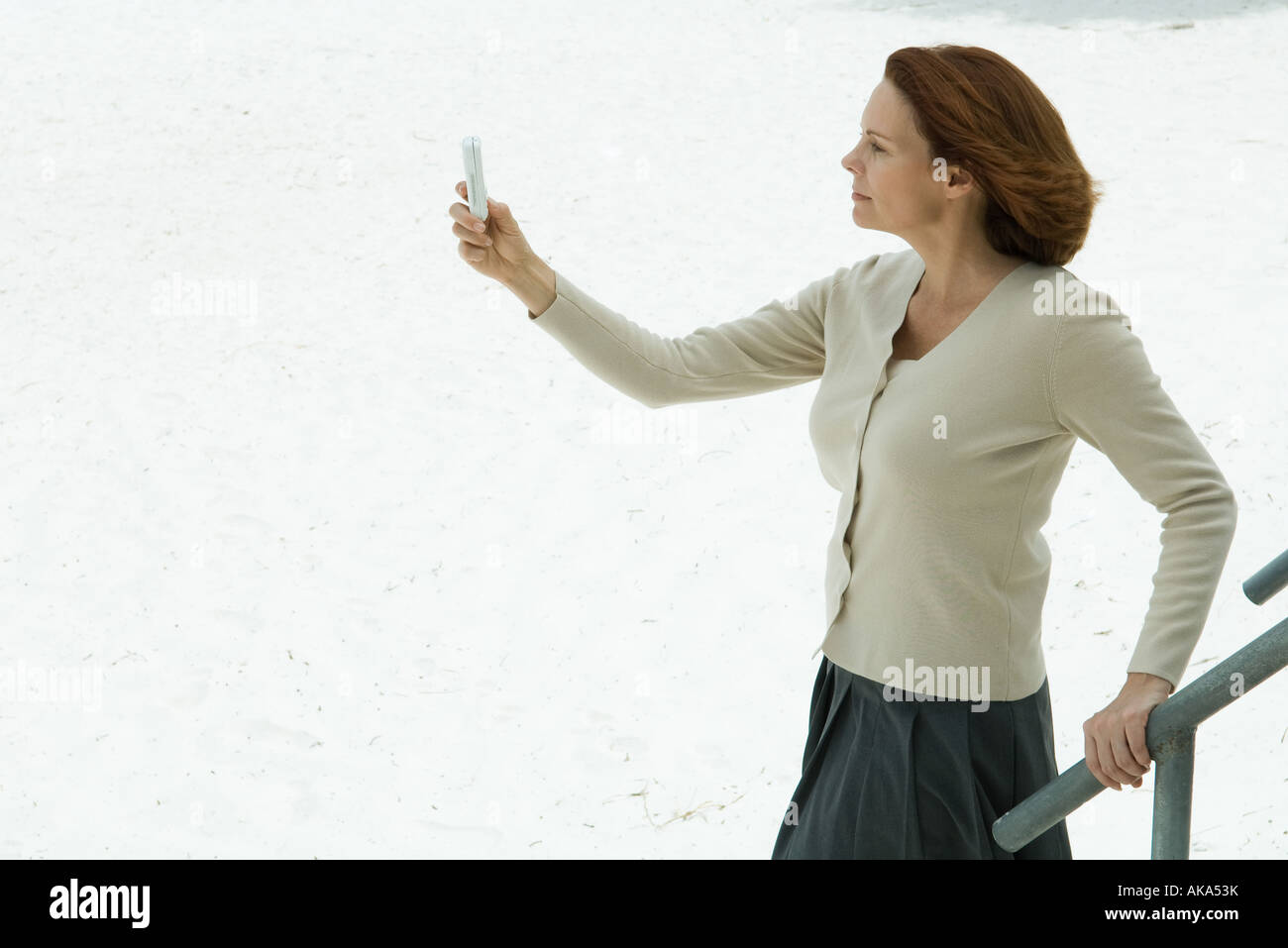 Woman Looking At Cell Phone Arm Outstretched Side View Stock Photo Alamy Woman Looking At Cell Phone Arm Outstretched Side View Stock Photo Alamy