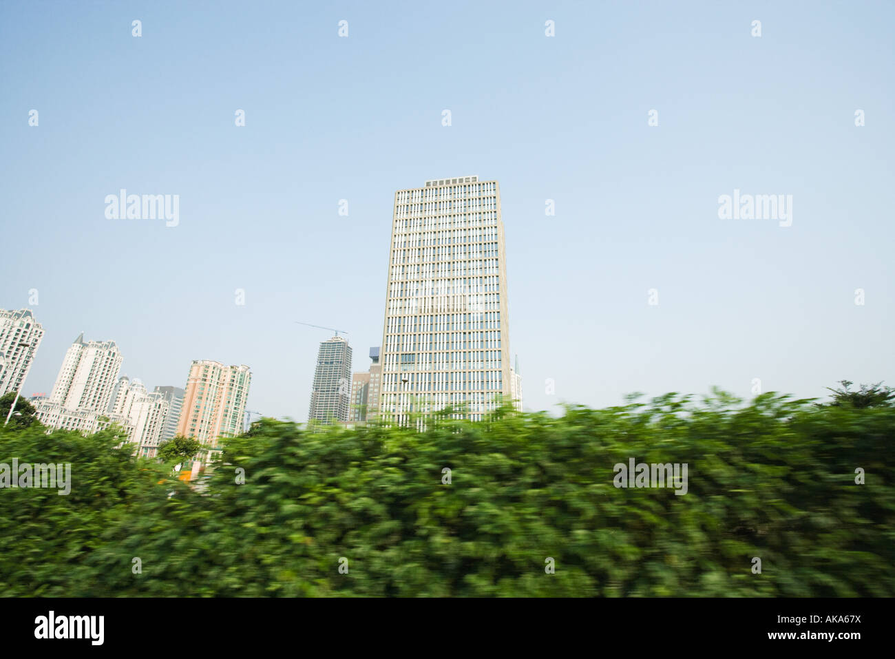 China, Guangdong Province, Guangzhou, high rises and hedge Stock Photo