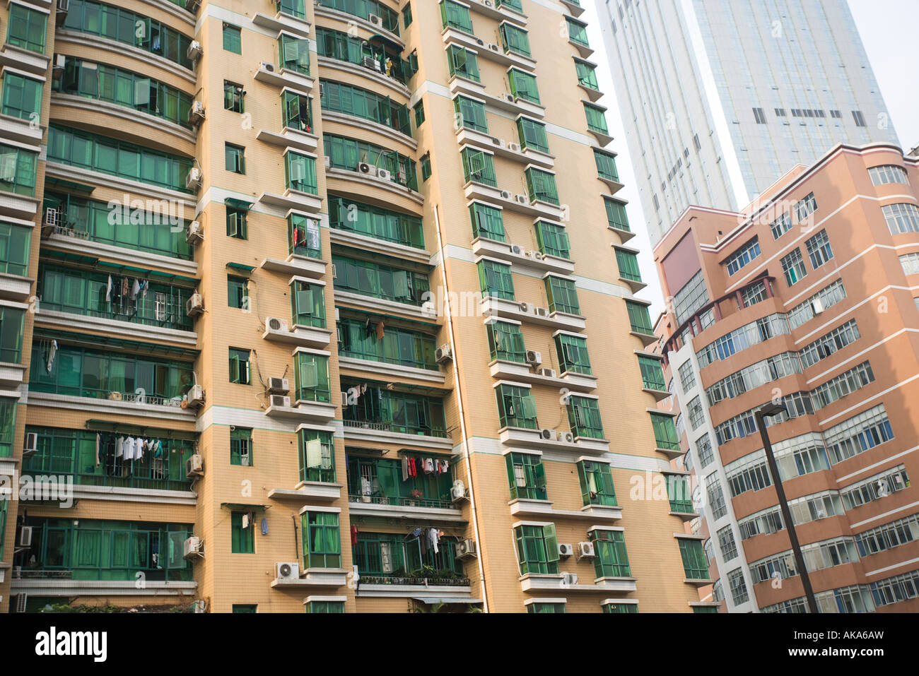 China, Guangdong Province, Guangzhou, high rise apartment building with green glass windows Stock Photo